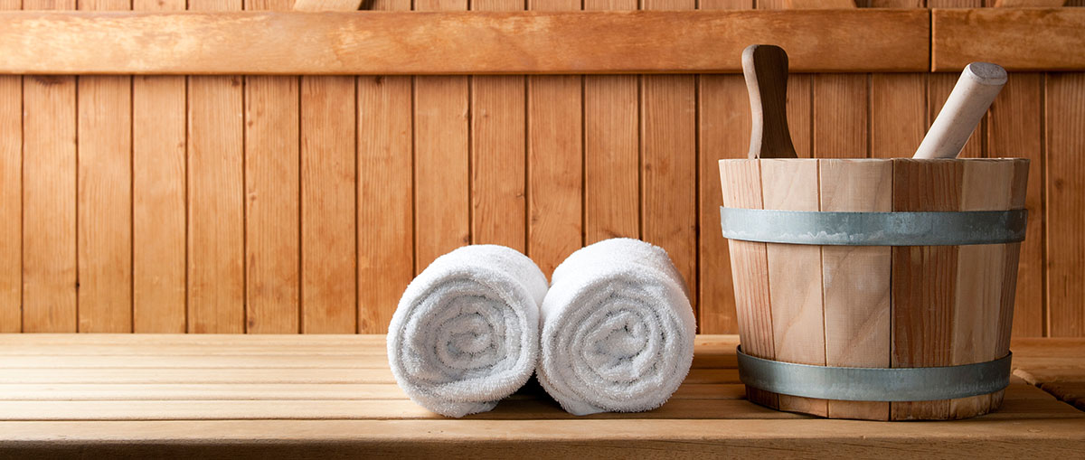 wooden pails and ladles with towels in a sauna